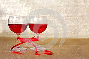 Two Glasses of Red Wine Tied Together with Bow