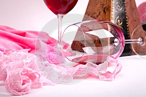Two glasses of red wine on a white background of about pink pant photo