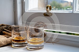 Two glasses of single malt scotch whisky served on old wooden window sill in Scottisch house in Edinburgh, Scotland, UK