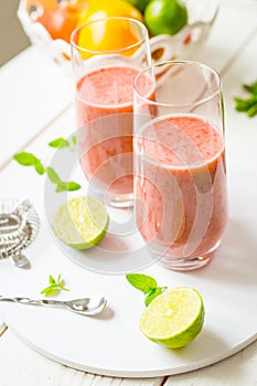 Two Glasses of Smoothie with Berries, Grapefruit, Lemon, Lime and Mint on White Wooden Background, Detox Time