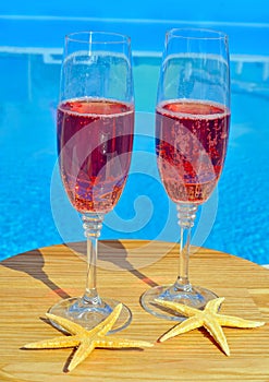 Two glasses of sparkling red wine and starfish