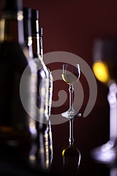 Two glasses of sparkling wine on the background of bottles