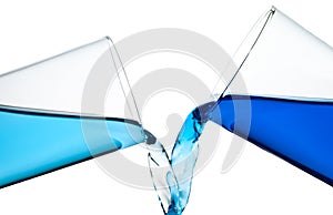 Two glasses spilling water or a similar blue liqui