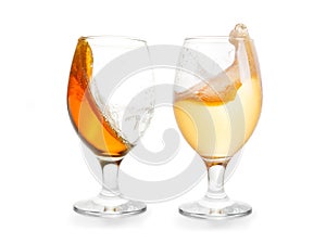 Two glasses of splashing beer. Dark and light one. Isolated with