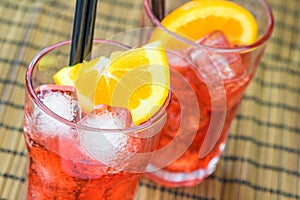 Two glasses of spritz aperitif aperol cocktail with two orange slices and ice cubes