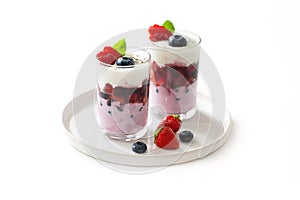 Two glasses with strawberry and blueberry dessert