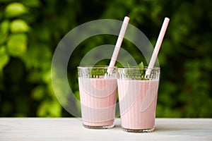 Two glasses of strawberry milkshake