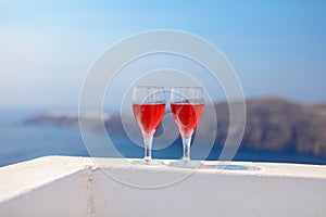 Two glasses of tasty red wine at sunset in Greece