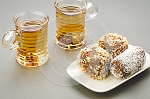 Two glasses of tea and cakes in a plate/two glasses of tea and c