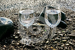 Two glasses of water on sea by water