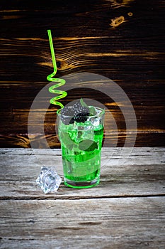 Two glasses of whiskey with ice cubes served on wooden planks. Vintage countertop with highlight and a glass of hard liquor delici