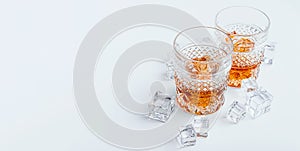 Two glasses of whiskey with ice on a white background with place for text