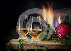 Two glasses of Whisky in front of Fire