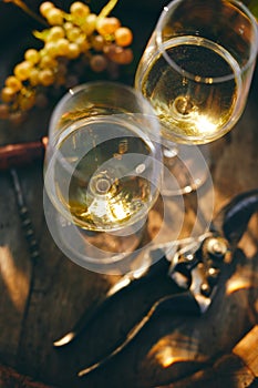 Two glasses of white wine on a barrel, top view