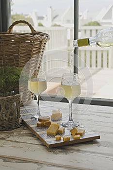 Two glasses of white wine with cheese, rustic, selective focus