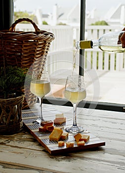 Two glasses of white wine with cheese, rustic, selective focus