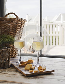 Two glasses of white wine with cheese, rustic, selective focus