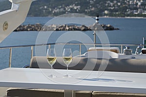 Two glasses of wine on the deck of a cruise yacht