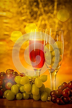 Cups of wine with grapes on a table