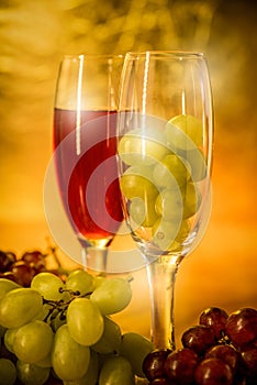 Cups of wine with grapes on a table