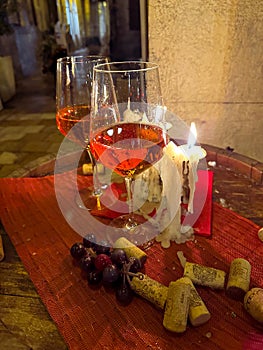 Two glasses of wine in a nighttime candle light dinner, fine dinning setting