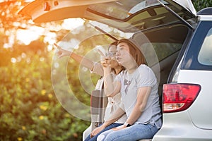 Two glorious lesbians relax on the car in park