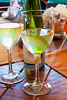 Two goblets with white wine on restaurant table