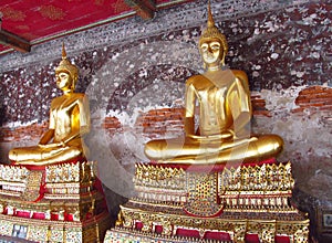 Two Gold-colored Buddha statue in Buddhist temple