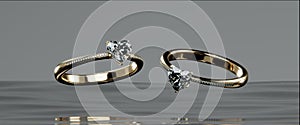 Two gold diamond rings float on the surface of the water. Heart diamond rings design with 3D