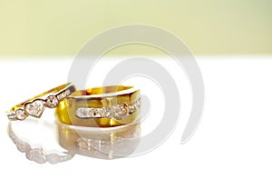 Two gold diamond wedding rings on white background.Golden Wedding Ring with Diamond on white background