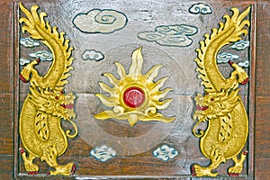 Two gold dragon on brown wood ,