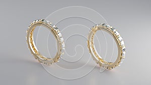 Two gold rings with diamonds surrounding the ring on a white background
