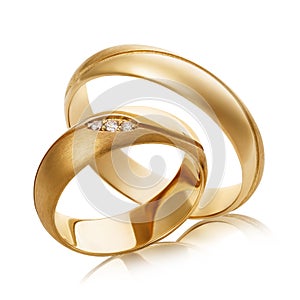 Two gold wedding rings with diamonds isolated on white background