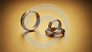 Two Gold Wedding Rings on Surface