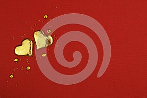 Two golden hearts on red background for Valentine Day