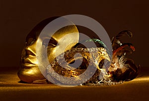 Two golden Venetian masks