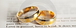 Golden wedding rings on bible book