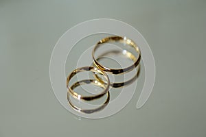 Two golden wedding rings with reflection photo