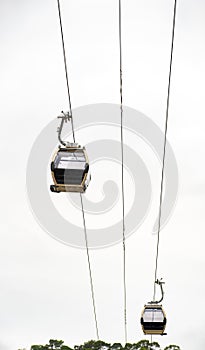 Two gondolas from the Vila Nova de Gaia neighborhood cable car suspended on the hanging cables from the Don Luis I Bridge to the