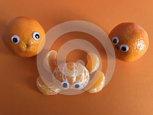 Creative fruit concept, googly eyed oranges