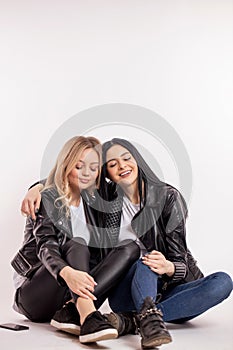 Two gorgeous stylish women appreciate their friendship