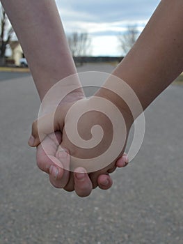 Two grade schoolers holding hands - Best Friends