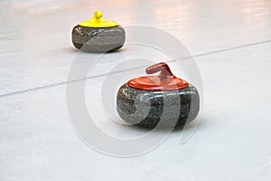 Two granite stones for curling game on the ice