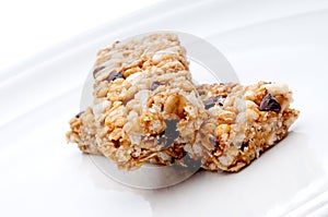 Two granola bars on a white plat