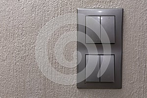 Two gray double light switches mounted on the wall