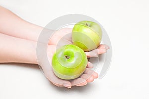 Two green apples in hands