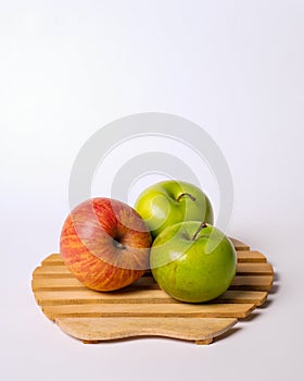 Two green apples and one red apple isolated on white background.