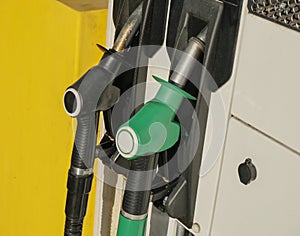 Two green and black gas pump nozzles at gas station close-up. Gas industry. Energy. Gas/diesel, benzine, petroleum station busines