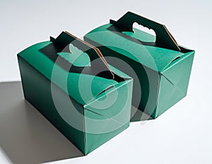Two Green Gift Boxes with Handles on White Background