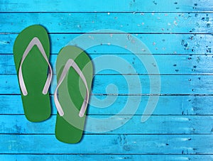 Two green man lifestyle relax flip flops on blue wooden floor